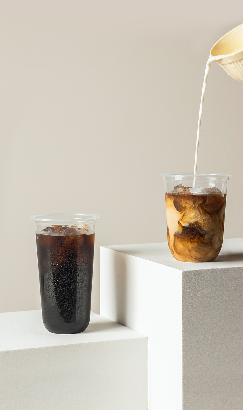 Pedestal display of innovative Takeout Goods Packaging cups filled with iced coffee.